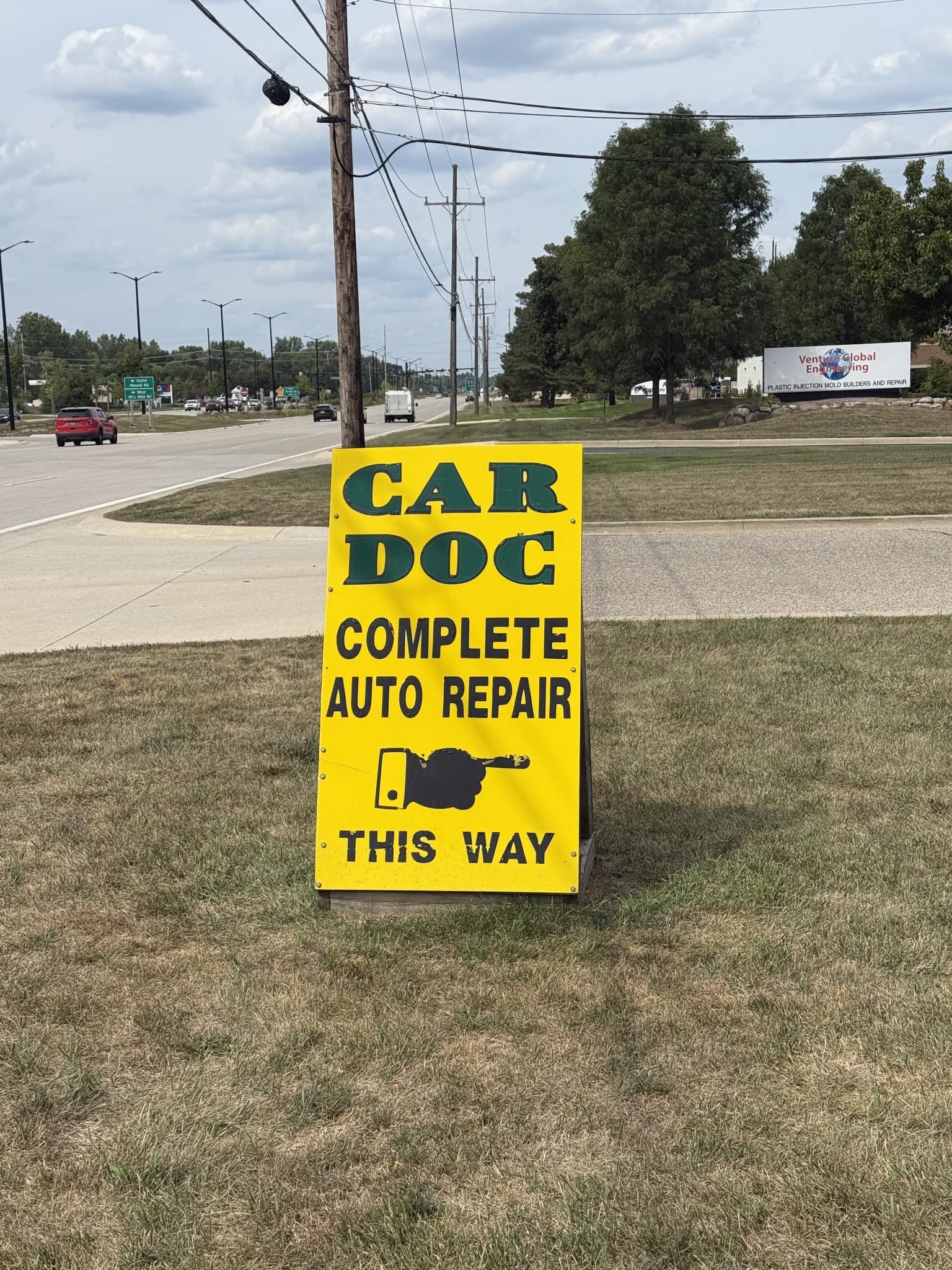 Yellow Car Doc roadside sign visible from Mound Road