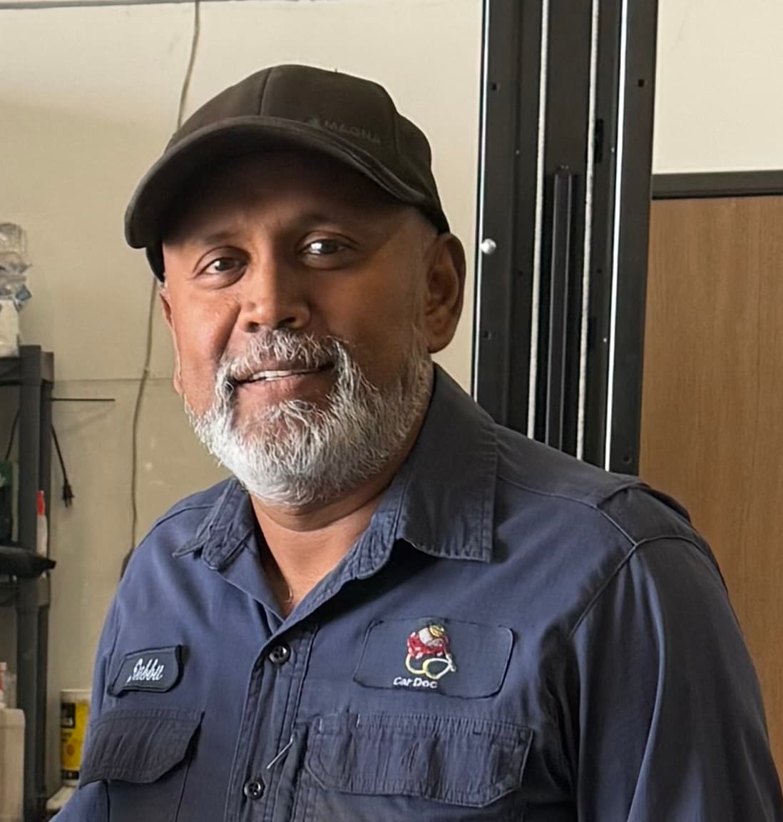 Subbu, owner of Car Doc, inside the repair shop