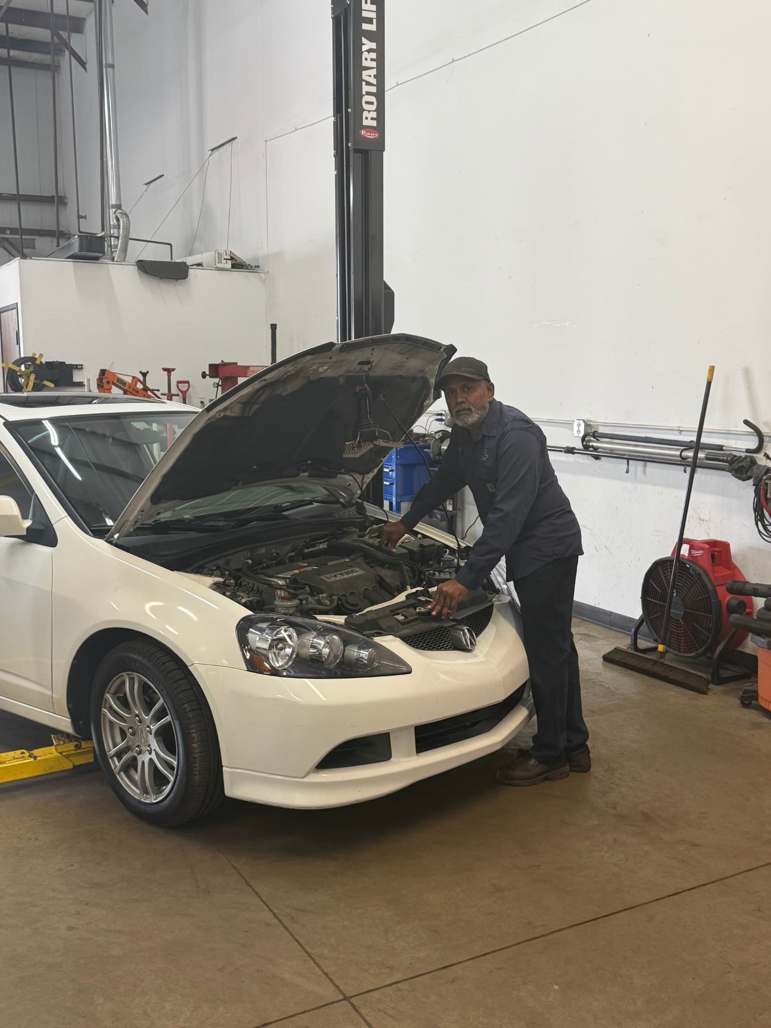 Subbu working on a vehicle in a Car Doc service bay
