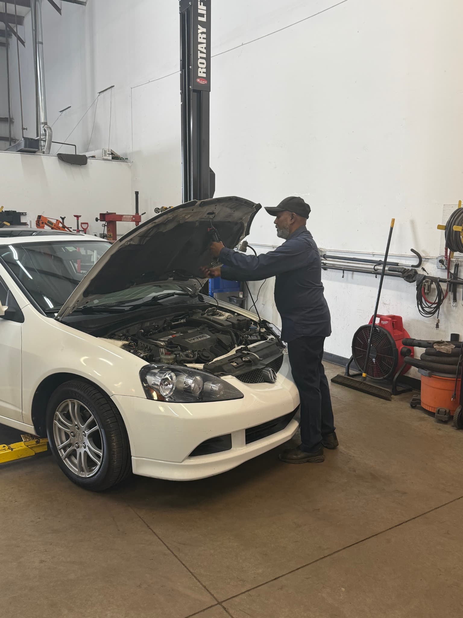 Subbu performing hands-on vehicle diagnostics and repair